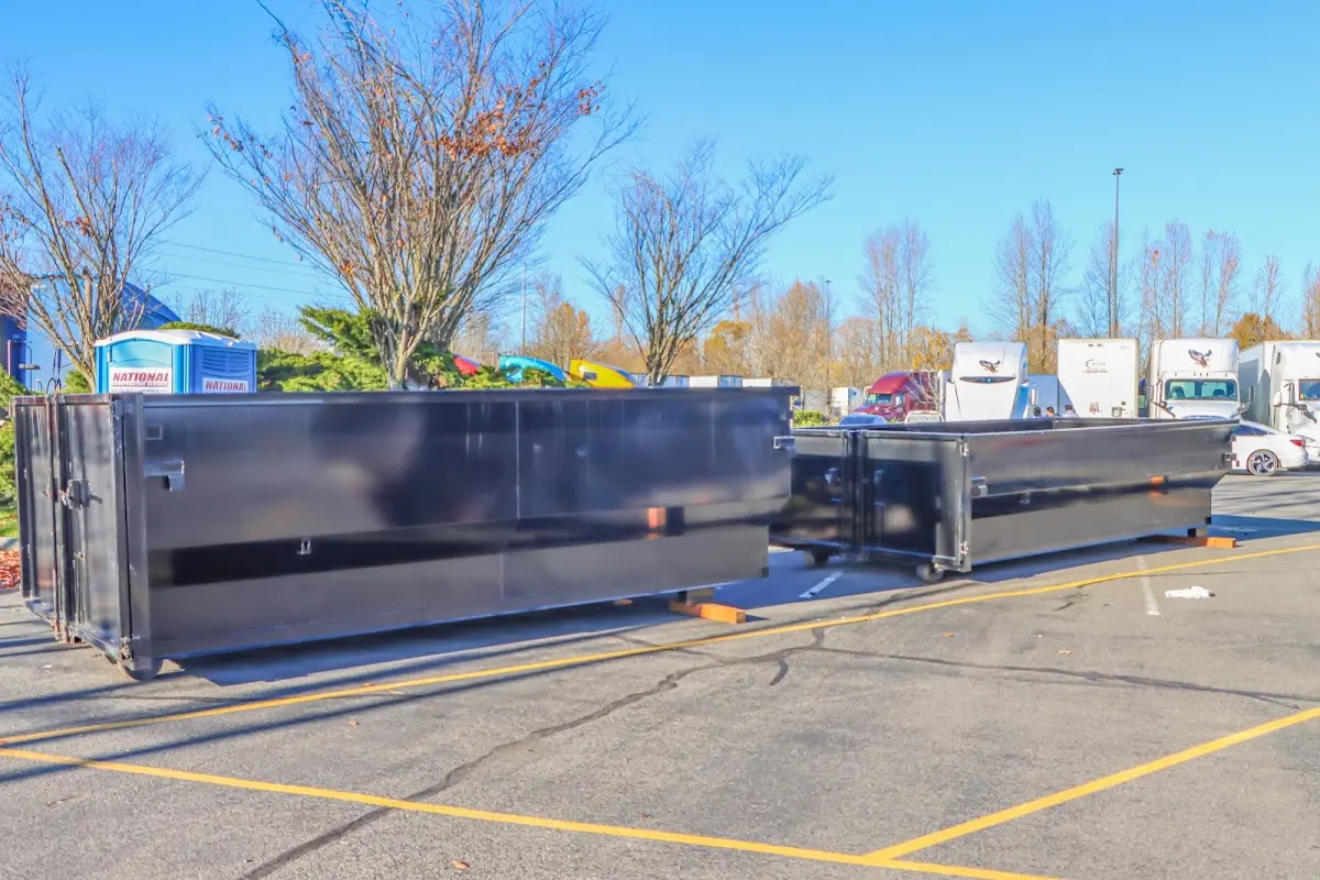 Professional dumpster rental service with roll-off container on residential driveway in Leighton